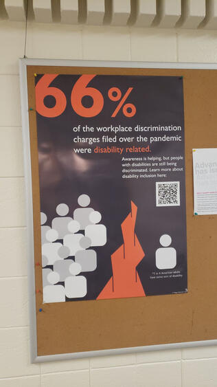 A photo of Maggie Behrendt. She is a young white woman that has wavy brown hair styled in a loose shoulder-length bob. She is also wearing large-framed glasses.